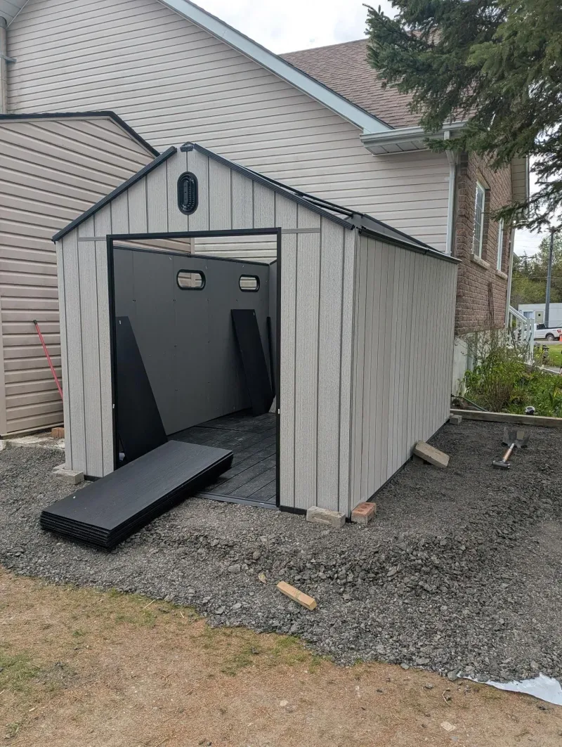 Resin shed installation in residential setting, Waterloo Ontario